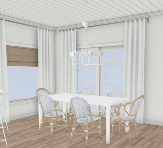 3D-rendered view of a bright and airy breakfast nook featuring a white dining table surrounded by rattan and white bistro-style chairs. The space is framed with crisp white drapery panels and natural woven Roman shades, and finished with a white petal-shaped chandelier overhead. Light wood flooring and shiplap ceiling add to the coastal, casual charm.